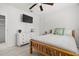 Bright bedroom featuring a twin bed, neutral decor, ceiling fan and updated flooring at 347 Patica Ne Rd, St Petersburg, FL 33702