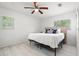 Cozy bedroom with a ceiling fan, a window, and neutral tones creating a relaxing atmosphere at 347 Patica Ne Rd, St Petersburg, FL 33702