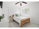 Bright bedroom featuring a twin bed, neutral decor, ceiling fan and updated flooring at 347 Patica Ne Rd, St Petersburg, FL 33702
