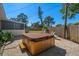 Wooden hot tub on a paved patio in the backyard, surrounded by a wooden fence at 347 Patica Ne Rd, St Petersburg, FL 33702