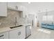 Well-lit kitchen featuring stainless steel dishwasher, herringbone backsplash, and modern finishes at 347 Patica Ne Rd, St Petersburg, FL 33702