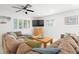 Bright living room featuring dual couches, ceiling fans, and ample natural light at 347 Patica Ne Rd, St Petersburg, FL 33702