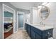 Bathroom with hexagon tile floors, blue vanity, and shiplap walls at 400 Westborough Ln, Safety Harbor, FL 34695