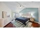 Bedroom with stylish decor, vaulted ceilings, wood floors, and bright windows at 400 Westborough Ln, Safety Harbor, FL 34695