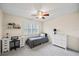 Cozy bedroom with neutral walls, gray accents, ceiling fan, and ample desk space at 400 Westborough Ln, Safety Harbor, FL 34695