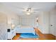 Bright bedroom features wood floors, ceiling fan, closet, blue area rug, and neutral walls at 400 Westborough Ln, Safety Harbor, FL 34695