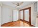 Dining room features hardwood floors, glass doors, and ample natural light at 400 Westborough Ln, Safety Harbor, FL 34695