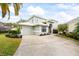 Charming home featuring a two-car garage, neutral paint, and a well-manicured lawn at 400 Westborough Ln, Safety Harbor, FL 34695