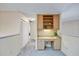 Hallway with a built-in desk area featuring cabinetry and ample workspace with a view at 400 Westborough Ln, Safety Harbor, FL 34695