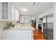 Bright kitchen featuring white cabinetry, stainless steel appliances, and gleaming hardwood floors at 400 Westborough Ln, Safety Harbor, FL 34695