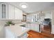 Well-lit kitchen features white cabinets, granite countertops and stainless steel appliances at 400 Westborough Ln, Safety Harbor, FL 34695