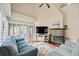 Cozy living room featuring a stacked stone fireplace, hardwood floors, and comfortable seating at 400 Westborough Ln, Safety Harbor, FL 34695