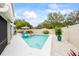 Sparkling pool area with lush landscaping and lounge seating, perfect for relaxation and fun at 400 Westborough Ln, Safety Harbor, FL 34695