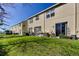Well-maintained backyard featuring green grass and a view of the building at 4676 66Th N Pl, Pinellas Park, FL 33781