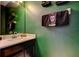 Close-up of a full bathroom with sink, dark vanity, and decorative hand towels at 4676 66Th N Pl, Pinellas Park, FL 33781