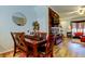 Open dining space with a wooden table, seating for four, and a stylish view into the living area at 4676 66Th N Pl, Pinellas Park, FL 33781