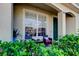 Inviting front porch featuring outdoor seating and decorative plants near the front door at 4676 66Th N Pl, Pinellas Park, FL 33781