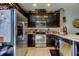 This kitchen features stainless steel appliances, granite countertops, and well-lit tile flooring, creating a functional cooking space at 4676 66Th N Pl, Pinellas Park, FL 33781
