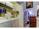 Laundry room equipped with modern appliances, efficient shelving, and seamlessly connected storage areas at 4676 66Th N Pl, Pinellas Park, FL 33781