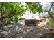 Spacious backyard with mature trees, offering ample shade, with a partially covered patio at 4812 Wynwood Dr, Tampa, FL 33615