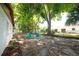 Mature shade trees offer ample shade in this backyard with a partially covered patio at 4812 Wynwood Dr, Tampa, FL 33615