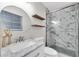 Bathroom featuring updated sink, toilet, and walk-in shower with decorative tile at 4812 Wynwood Dr, Tampa, FL 33615