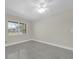 Bright bedroom featuring a ceiling fan, a large window, and polished concrete floors at 4812 Wynwood Dr, Tampa, FL 33615