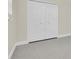 Bedroom closet featuring full-length bifold doors with round knobs and off-white trim at 4812 Wynwood Dr, Tampa, FL 33615
