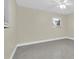 Bedroom with two windows, neutral paint, ceiling fan, and speckled floor at 4812 Wynwood Dr, Tampa, FL 33615