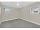 Bedroom featuring two windows with wood blinds, a ceiling fan, and neutral walls at 4812 Wynwood Dr, Tampa, FL 33615