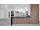 Modern kitchen featuring stainless steel appliances, marble backsplash and a black marble waterfall island at 4812 Wynwood Dr, Tampa, FL 33615