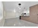 Open-concept living space with a modern kitchen featuring stainless appliances and a black marble waterfall island at 4812 Wynwood Dr, Tampa, FL 33615