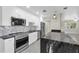 Modern kitchen featuring stainless steel appliances, marble backsplash and a black marble waterfall island at 4812 Wynwood Dr, Tampa, FL 33615