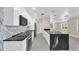 Modern kitchen featuring stainless steel appliances, marble backsplash and a black marble waterfall island at 4812 Wynwood Dr, Tampa, FL 33615