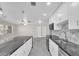 Open-concept kitchen showcases a large island and sleek, white cabinets with stainless steel appliances at 4812 Wynwood Dr, Tampa, FL 33615
