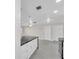 Bright, modern kitchen features a large island with a black countertop and white cabinets at 4812 Wynwood Dr, Tampa, FL 33615