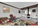 A covered patio with wicker seating, a cozy fireplace, and access to the backyard at 4812 Wynwood Dr, Tampa, FL 33615