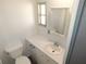 Bathroom with a sink, decorative mirror, toilet, and ample counter space at 5244 Betty St, Zephyrhills, FL 33542