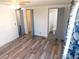 Bedroom with multiple doors and laminate flooring, plus convenient access to other rooms at 5244 Betty St, Zephyrhills, FL 33542