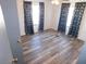 Bedroom featuring laminate floors, blue curtains, and ample natural light at 5244 Betty St, Zephyrhills, FL 33542