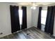 Bedroom with two windows, a ceiling fan, and dark curtains for privacy and comfort at 5244 Betty St, Zephyrhills, FL 33542