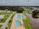 Aerial shot of a community pool area with multiple pools, lounge chairs, and well-maintained grounds at 5244 Betty St, Zephyrhills, FL 33542