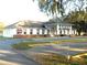 Community clubhouse with a white facade, decorative columns, and ample parking at 5244 Betty St, Zephyrhills, FL 33542
