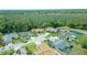 Aerial view of a suburban home featuring a lush landscape and a screened-in pool at 5343 Sagamore Ct, New Port Richey, FL 34655