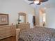 Comfortable bedroom with a ceiling fan, hardwood floors, and ample closet space at 5343 Sagamore Ct, New Port Richey, FL 34655