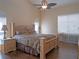 Cozy bedroom featuring a decorative ceiling fan, plush bedding, and hardwood flooring at 5343 Sagamore Ct, New Port Richey, FL 34655