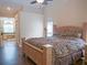 Relaxing bedroom with a ceiling fan, hardwood floors, and en-suite bathroom with tub at 5343 Sagamore Ct, New Port Richey, FL 34655