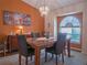 Dining room with a large window, chandelier, and a dining set with chairs and a table at 5343 Sagamore Ct, New Port Richey, FL 34655