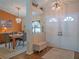 Inviting entryway featuring double doors, elegant lighting, and a view into the dining area at 5343 Sagamore Ct, New Port Richey, FL 34655