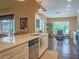 Open concept kitchen with island, stainless steel appliances, and a view of the dining area at 5343 Sagamore Ct, New Port Richey, FL 34655